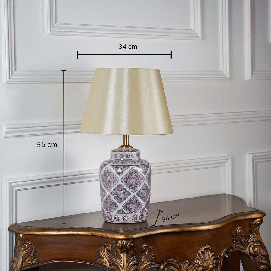 White ceramic table lamp with beige shade 55 cm tall and 34 cm wide displayed on console for size reference.