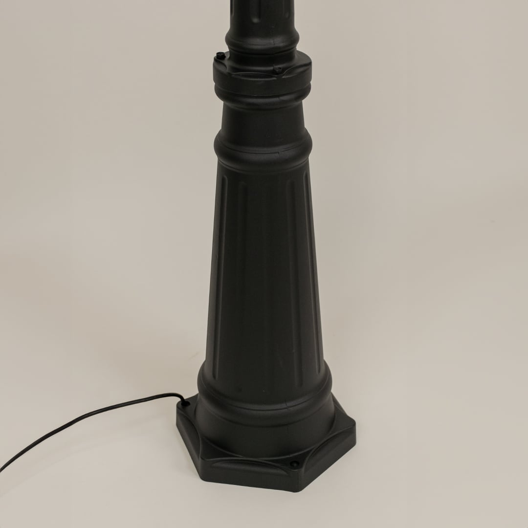 Detailed closeup of black lantern top with scroll arm and clear glass design ideal for enhancing garden walkway driveway and exterior lighting Decor.