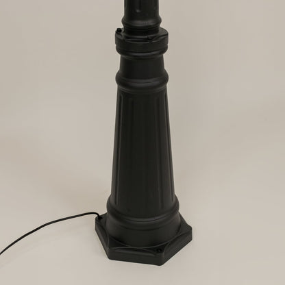 Detailed closeup of black lantern top with scroll arm and clear glass design ideal for enhancing garden walkway driveway and exterior lighting Decor.
