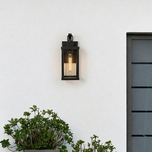 Modern black rectangular outdoor wall light lifestyle image with clear glass panels mounted on a white exterior stucco wall.