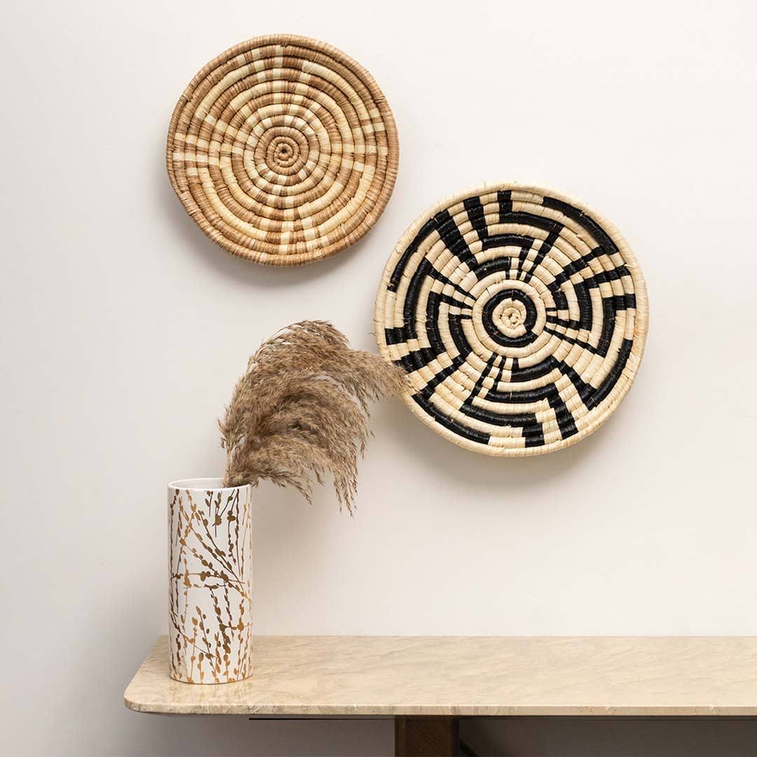 Handcrafted brown and black woven seagrass wall basket set displayed in lifestyle living room for boho home decor styling.