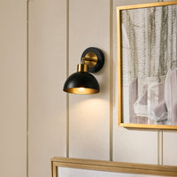 Modern black metal wall light with dome shade for bedroom hallway and contemporary home interiors with warm lighting.