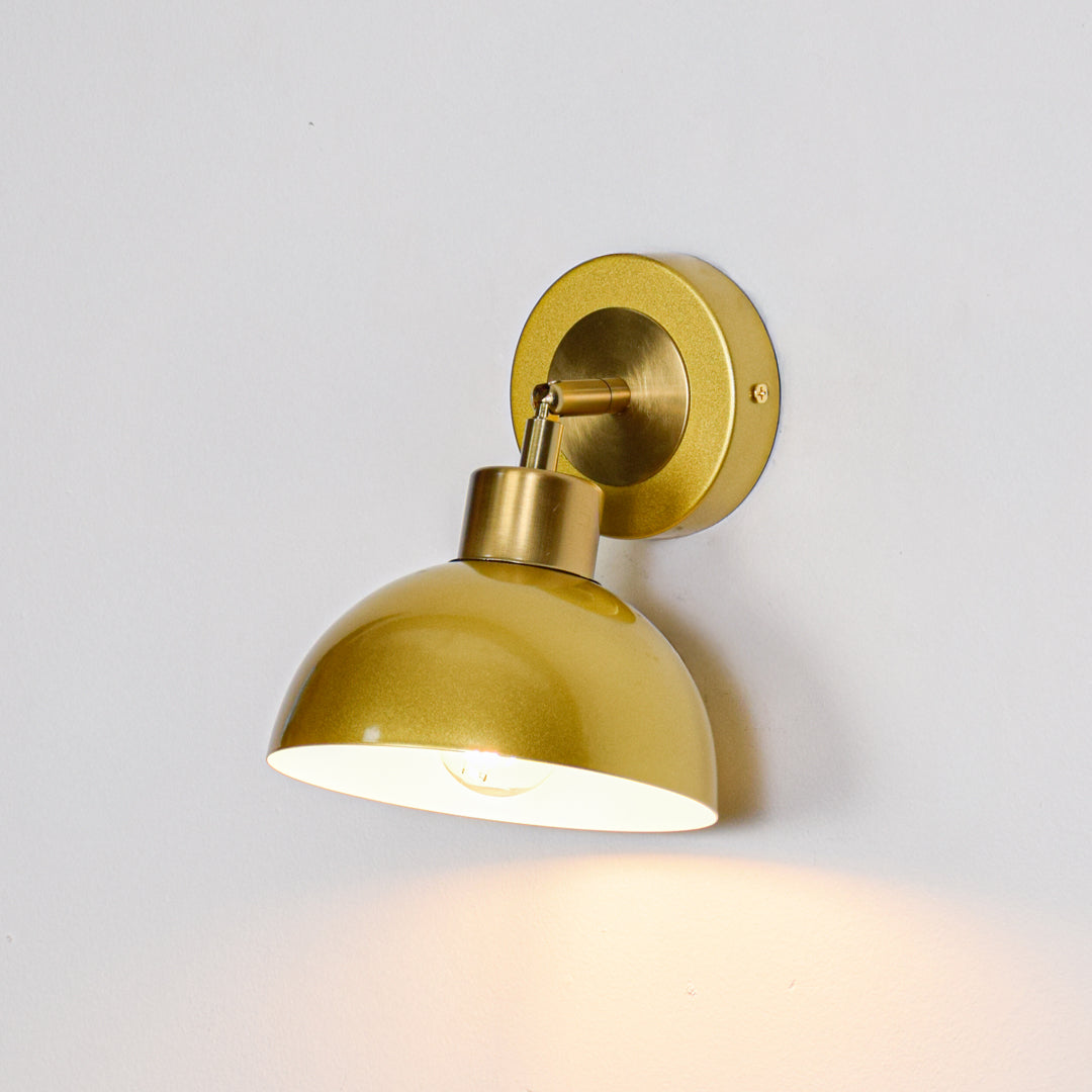 Gold finish wall light with dome shade perfect for modern bedroom or hallway wall decor placement on clean background.