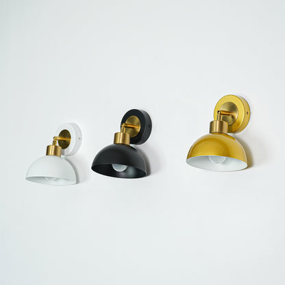 Set of wall lights with white black and gold dome shades perfect for modern bedroom or hallway wall decor placement.