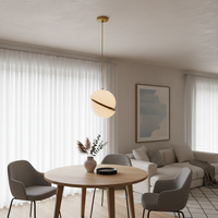Brass and chrome pendant light above dining table adding modern luxury and warm ambient lighting to interiors.