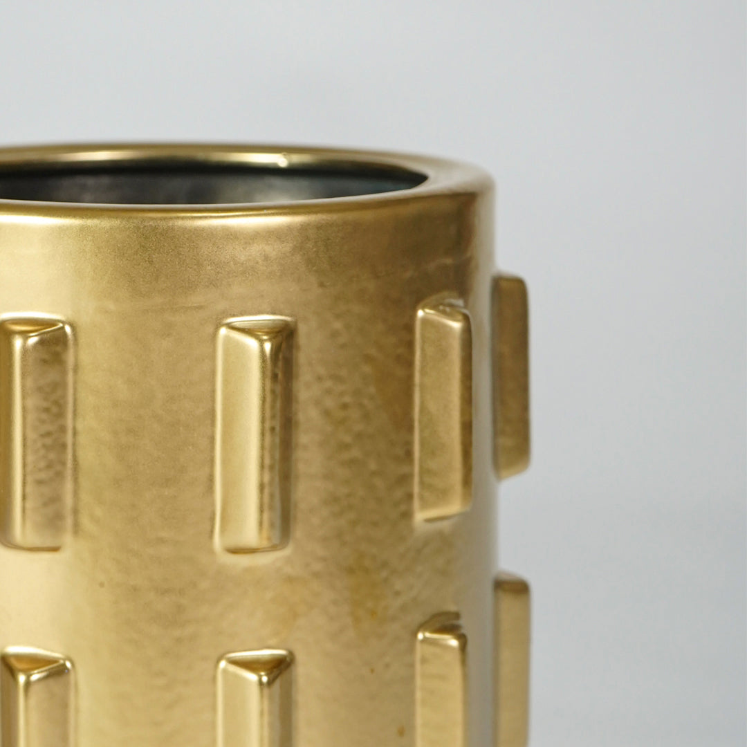 Closeup image of gold metal decor vase for luxury console table styling with modern textured finish display.
