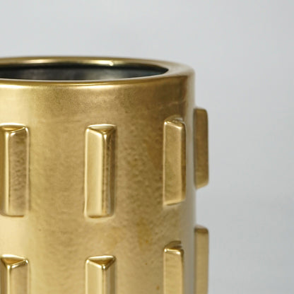 Closeup image of gold metal decor vase for luxury console table styling with modern textured finish display.