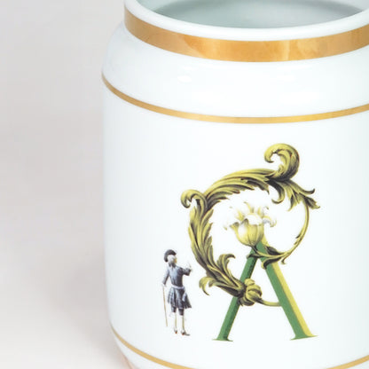 Closeup image of white ceramic decorative jar with gold detailing for luxury tabletop decor styling display.