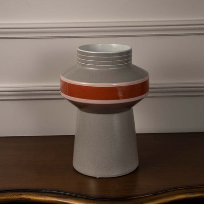 Modern grey ceramic vase with glossy red and pink band accent styled for contemporary living room and office table decor.