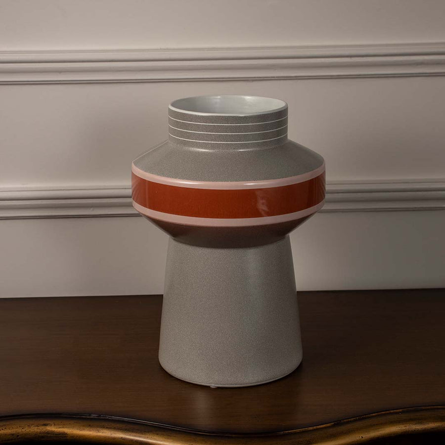 Modern grey ceramic vase with glossy red and pink band accent styled for contemporary living room and office table decor.