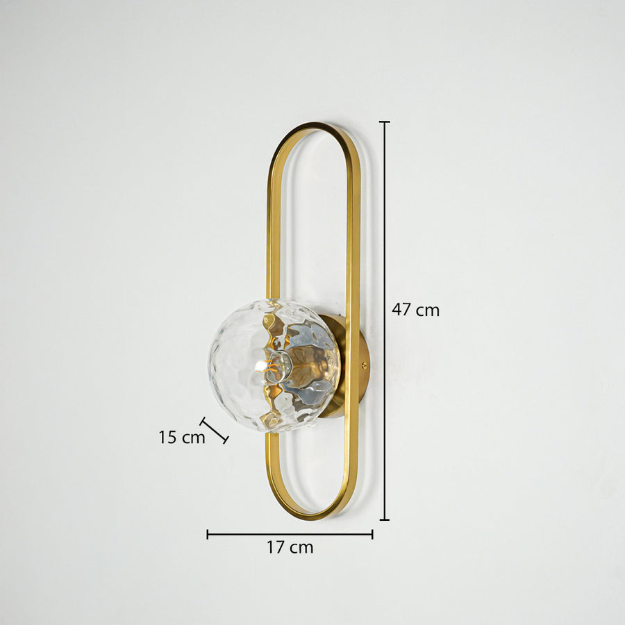 Gold metal wall light with sculpted glass shade sized 47 cm height 17 cm width and 15 cm depth ideal for wall decor installation.