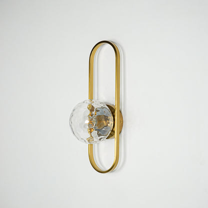 Gold metal wall light with sculpted glass shade and sleek frame design perfect for modern interior wall decor on clean background.