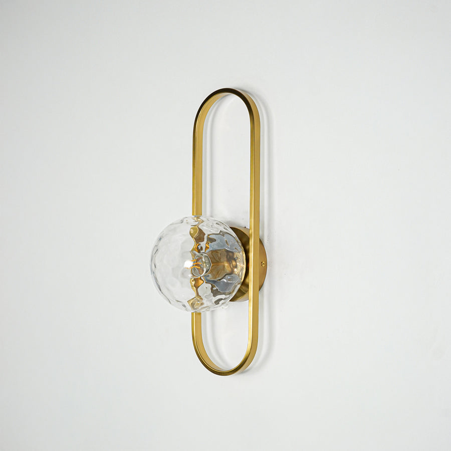 Gold metal wall light with sculpted glass shade and sleek frame design perfect for modern interior wall decor on clean background.