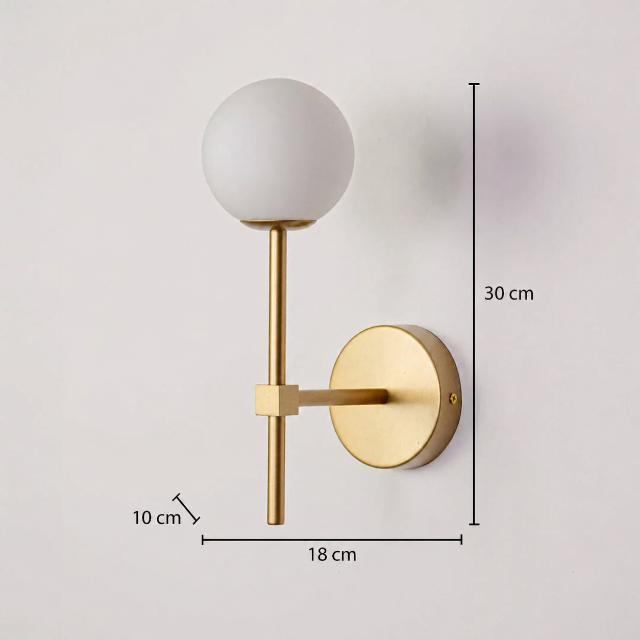 This gold-colored wall light is depicted with dimensions of 30 cm in height, 18 cm in width, and a wall depth of 10 cm, clearly showcasing the product's proportions against a deeply textured background.