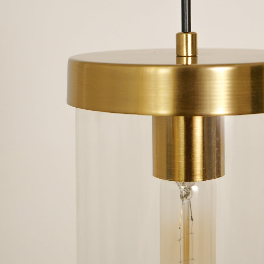 Closeup of brushed brass canopy and clear glass tube showcasing premium craftsmanship details.