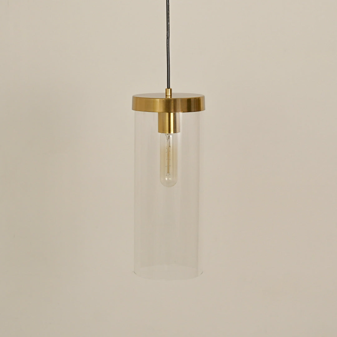 Clear glass tube pendant light with brushed brass finish designed for modern interiors.