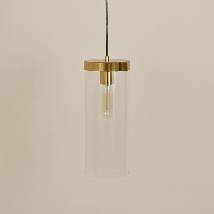 Clear glass tube pendant light with brushed brass finish designed for modern interiors.