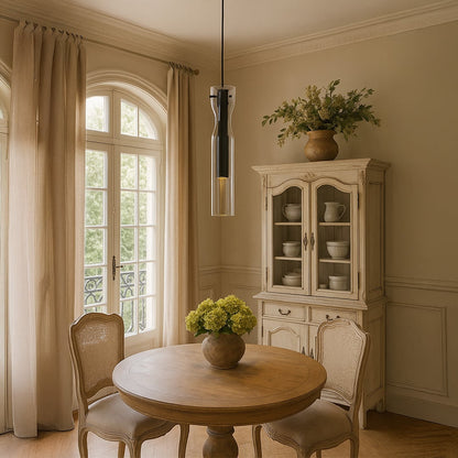 Elegant black glass pendant light hanging in a warm dining room setting with classic wooden furniture soft drapes and natural daylight filling the space.