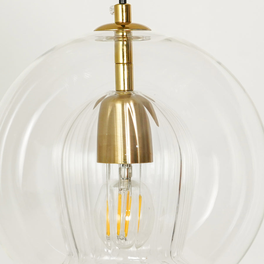 Closeup image of glass round ball hanging pendant lamp for elegant dining room decor styling and modern home room lighting.