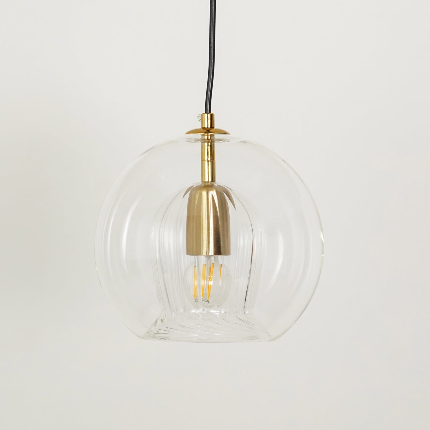 White background image of glass round ball hanging pendant lamp for elegant dining room decor styling and modern lighting.