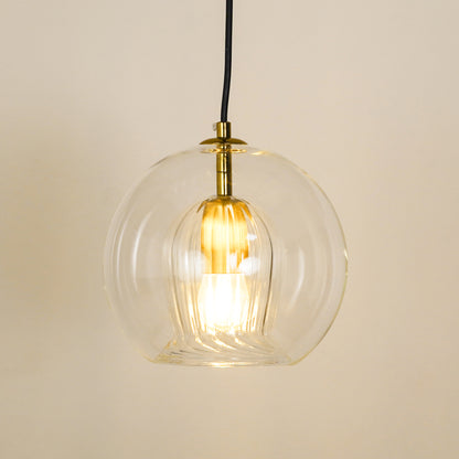 White background image of illuminated glass round ball hanging pendant lamp for elegant dining room decor interior styling.