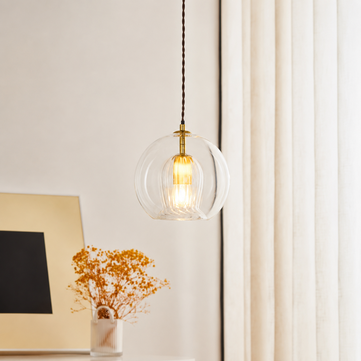 Lifestyle image of glass round ball hanging pendant lamp for elegant dining room decor styling and modern home room lighting.