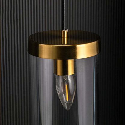 Detailed closeup of metal cage pendant light showing the curved wire frame warm glowing bulb and central metallic holder emphasizing texture and craftsmanship.