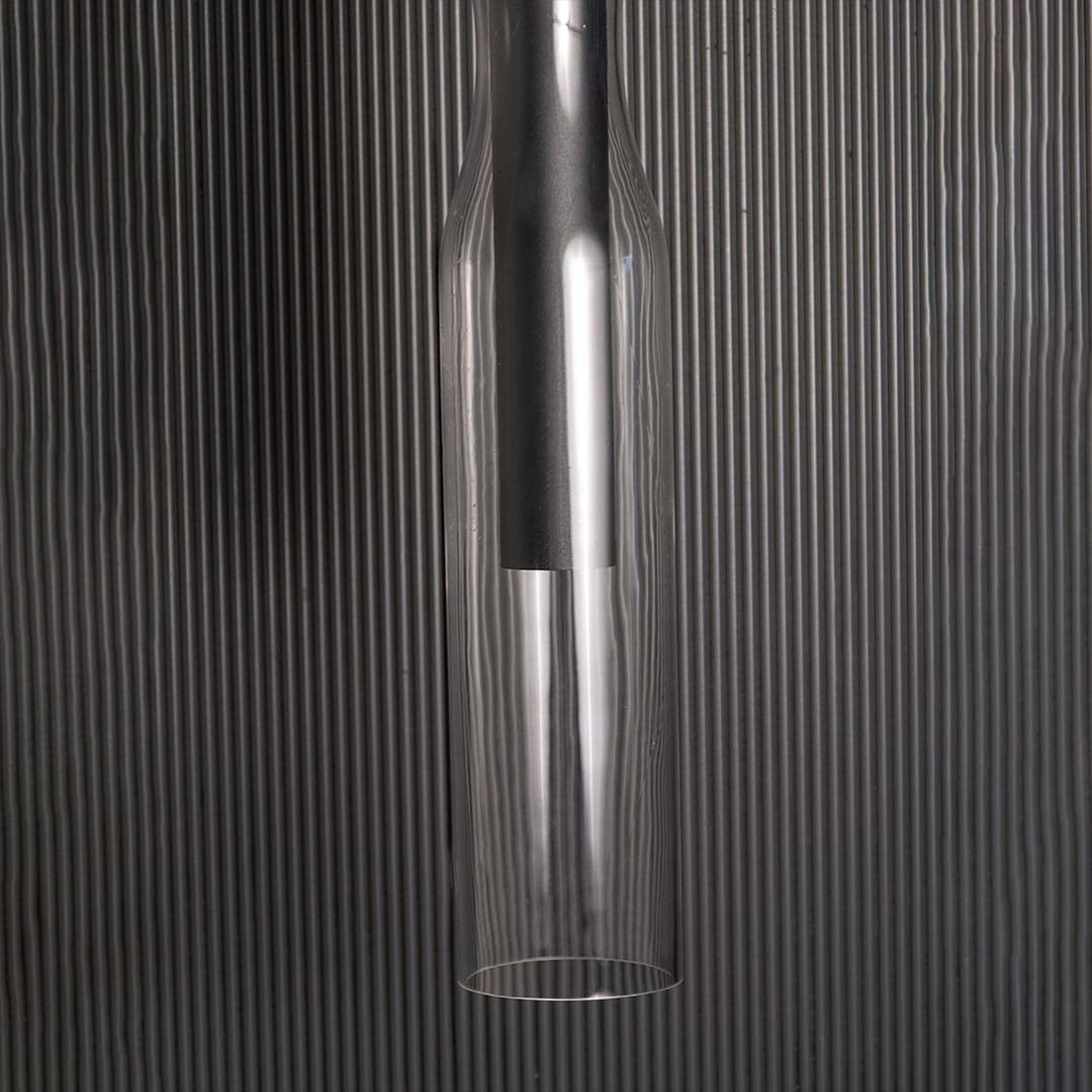 Detailed closeup of the black pendant light showing the upper mounting section and clear glass edges that enhance its clean modern aesthetic.