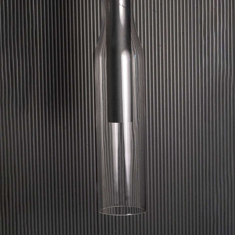 Detailed closeup of the black pendant light showing the upper mounting section and clear glass edges that enhance its clean modern aesthetic.