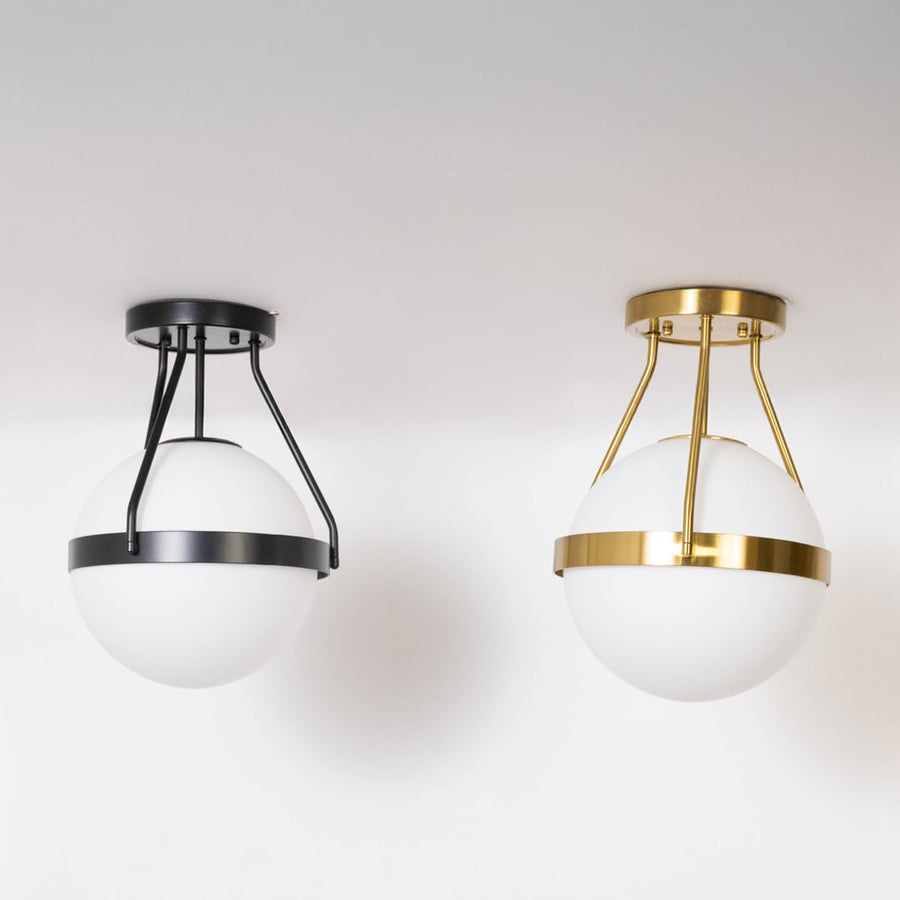 Black and gold ceiling lights with frosted glass globes in off mode displayed on white background for home decor.