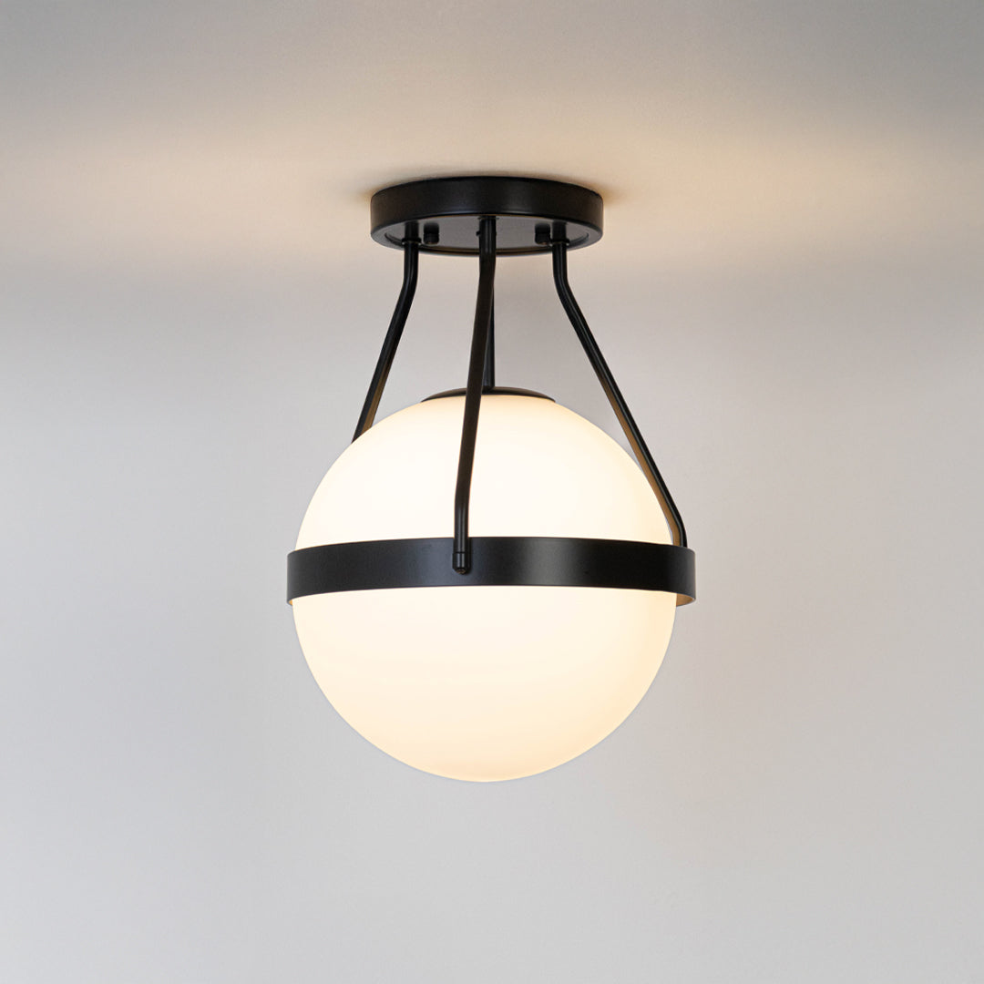 Modern black metal ceiling light with frosted white glass globe for contemporary bedroom and premium decor styling spaces.
