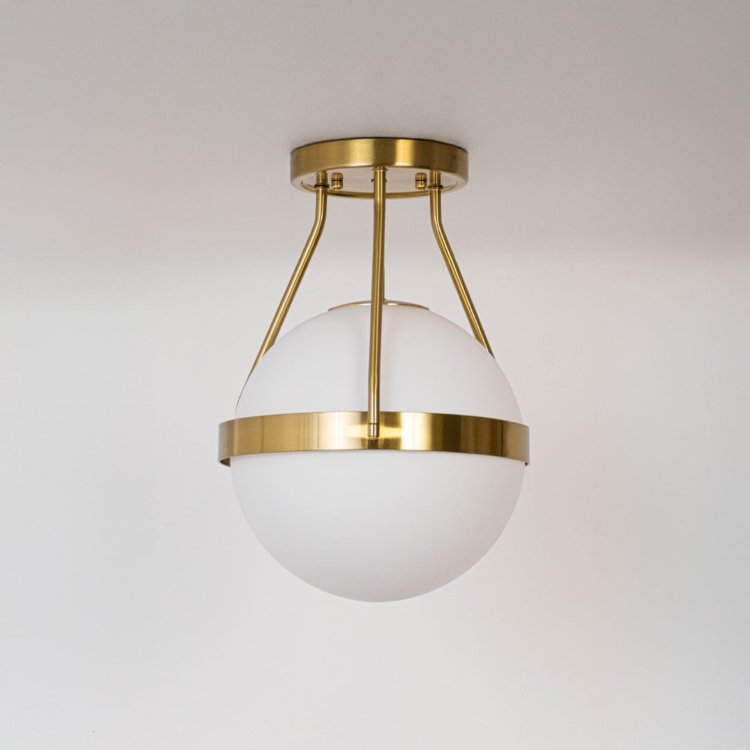 Gold ceiling light with frosted glass globe and modern frame in off mode displayed on white background for home decor.