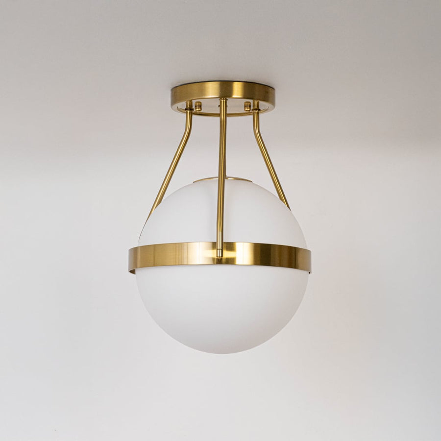 Gold ceiling light with frosted glass globe and modern frame in off mode displayed on white background for home decor.