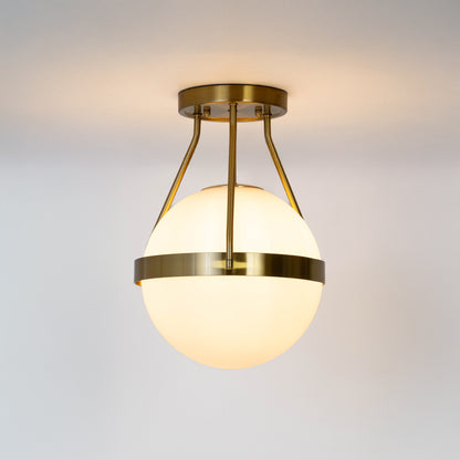 Modern gold metal ceiling light with frosted white glass globe for luxury interior decor and stylish hallway spaces.
