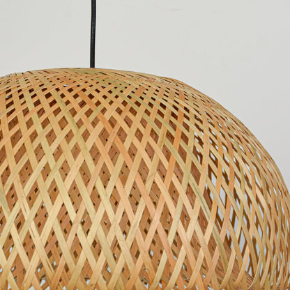 Closeup of woven natural rattan pendant light showcasing intricate texture and artisanal craftsmanship.