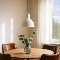 Black metal pendant light enhancing bright dining spaces with timeless elegance and ambient lighting.