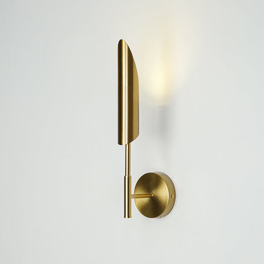 Gold metal wall light with vertical tube design emitting soft warm glow ideal for bedroom or hallway wall decor placement.