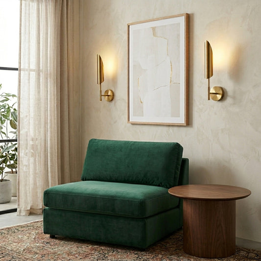 Modern gold wall light with sleek vertical design styled beside sofa creating warm ambient glow for elegant living room decor.