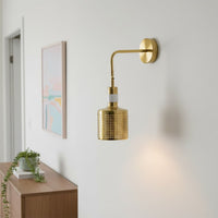 Modern gold metal wall light with perforated shade for elegant hallway and luxury decor styling spaces.