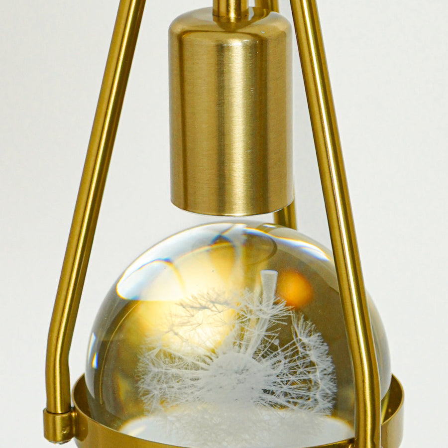 Detailed view of textured clear glass and gold metal pendant light showcasing premium finish and texture.