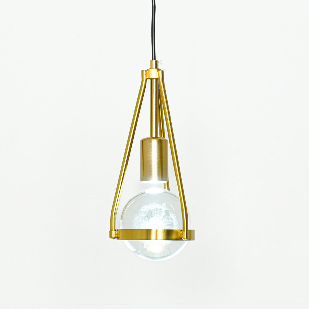 Textured clear glass and gold metal pendant light with geometric frame for modern home decor spaces.