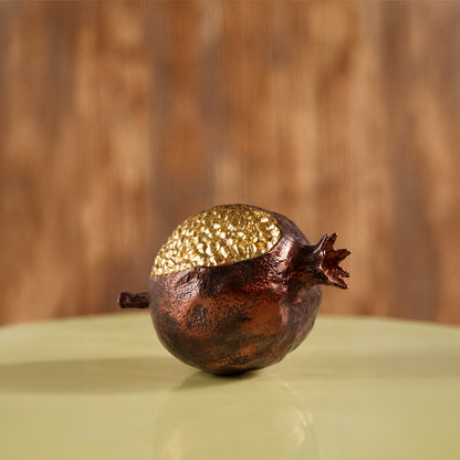 Gold and brown decorative pomegranate sculpture for artistic tabletop styling and contemporary home decor displays.