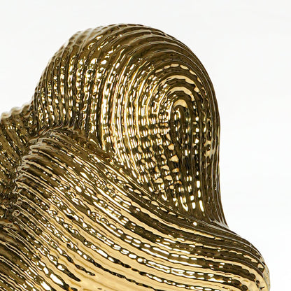 Textured gold metal artistic swirl sculpture for elegant shelf and console decor styling.