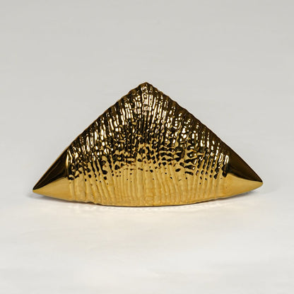 Gold striped ceramic triangle table accent isolated on clean white background for statement decor styling.