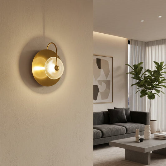 Modern gold metal wall light with textured glass shade for luxury living room and elegant home decor spaces.