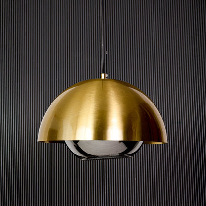Golden dome pendant light with glass diffuser modern ceiling lamp for dining and living room stylish interiors black background.