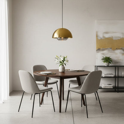 Brass dome pendant light above dining table creating refined ambiance and timeless modern appeal.