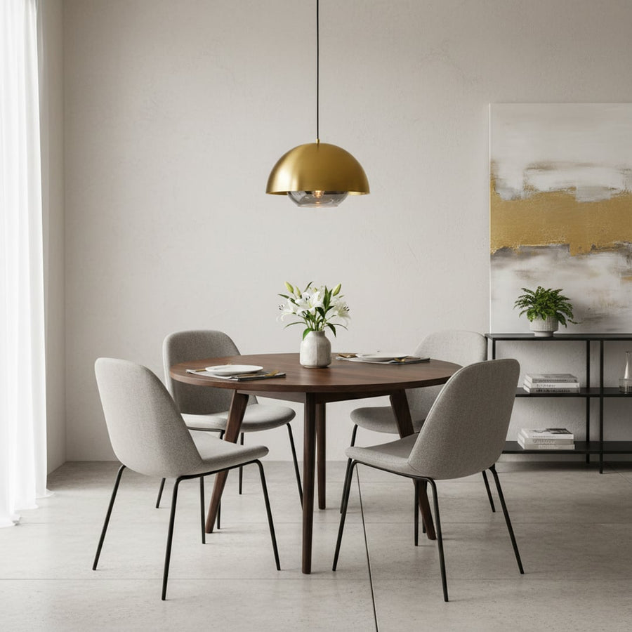 Brass dome pendant light above dining table creating refined ambiance and timeless modern appeal.