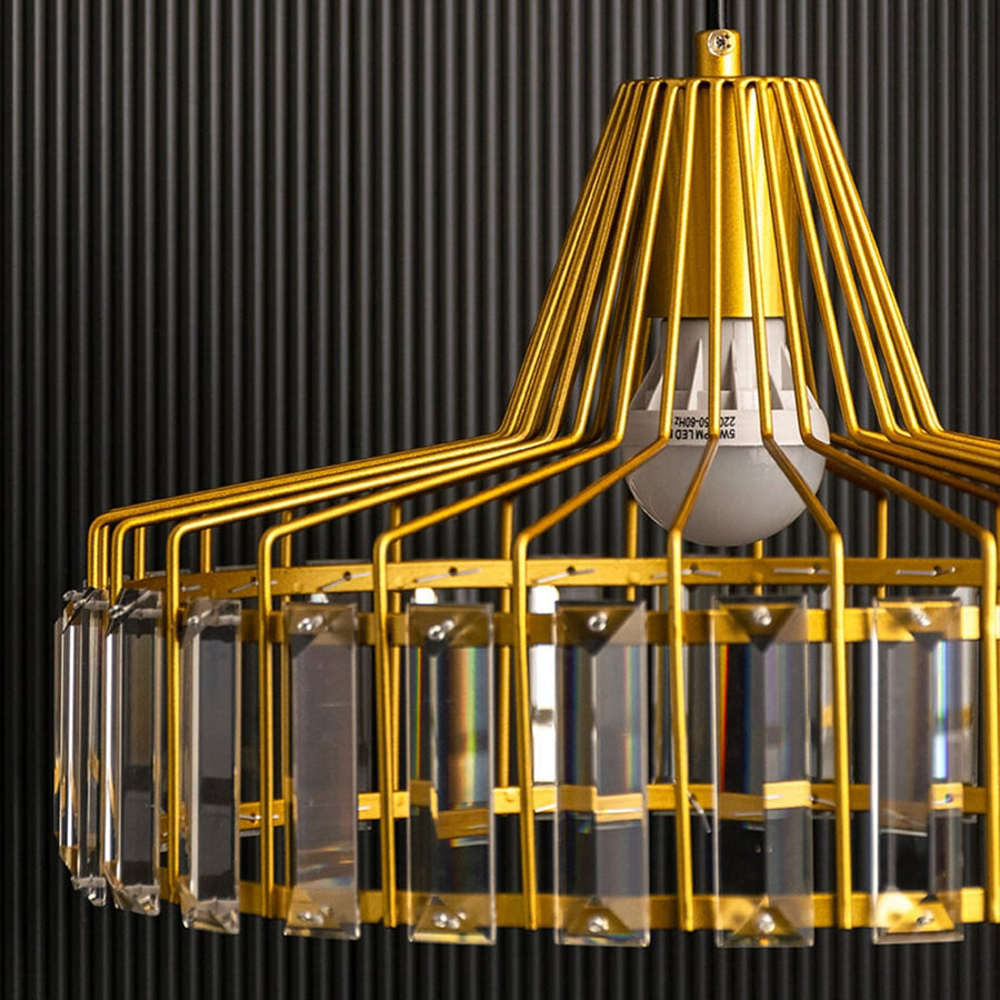 Detailed closeup of the gold crystal pendant light showing the refined metal frame and crystal elements capturing the fine craftsmanship from a tight angle.