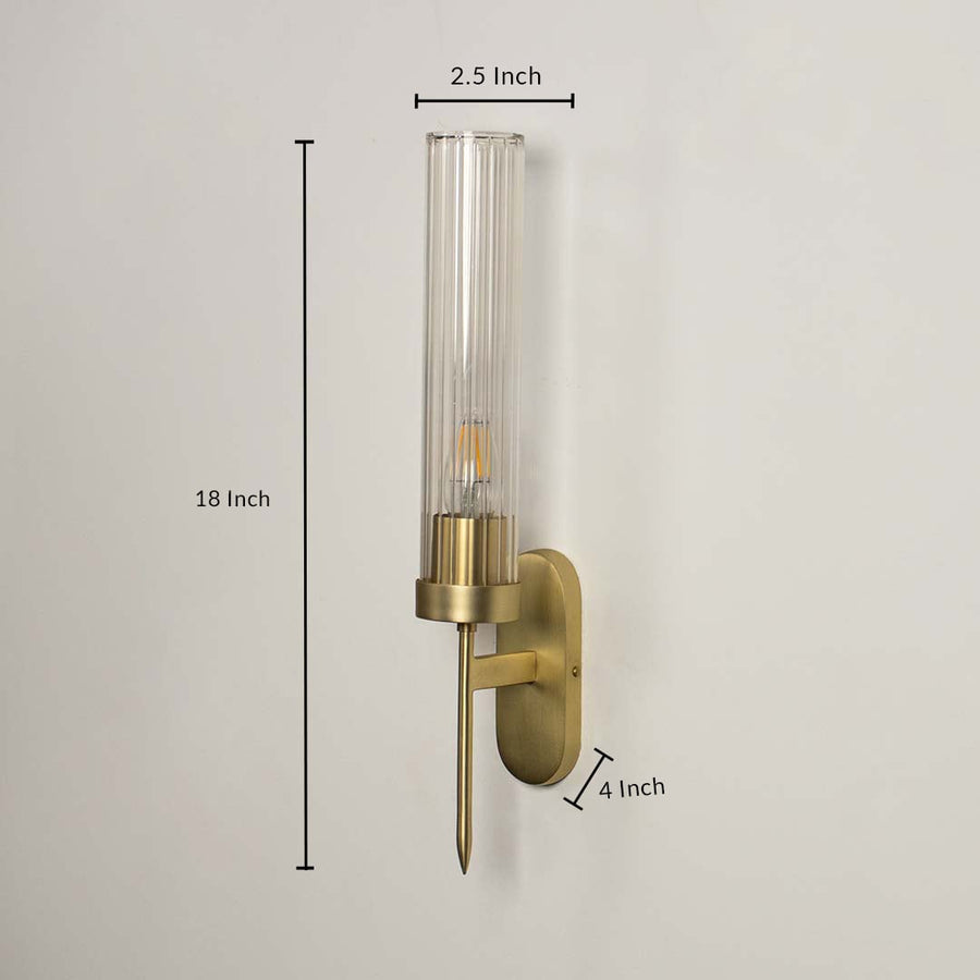 Contemporary brass metal wall light measuring 58 cm height with clear glass shade for luxury interiors.